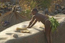 14: Koma woman working millet